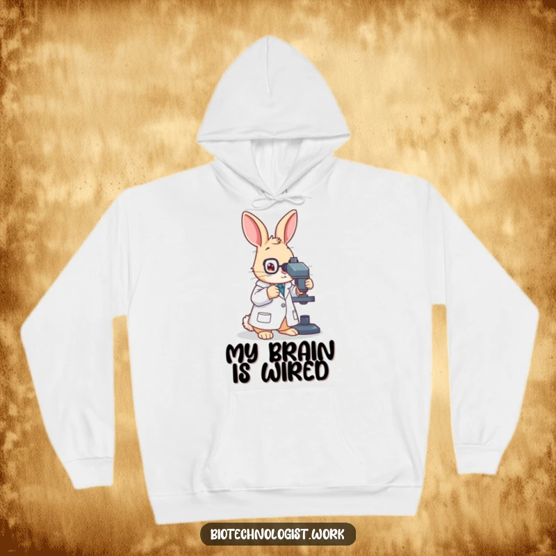 Funny, warm hoodie with a diligent rabbit scientist in a lab coat, intently adjusting a microscope, looking smart and amusing.