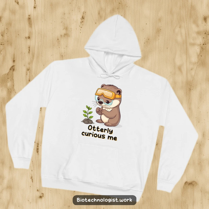 Funny otter hoodie depicting a playful otter wearing safety goggles while intently examining a tiny plant, symbolizing careful nature study.